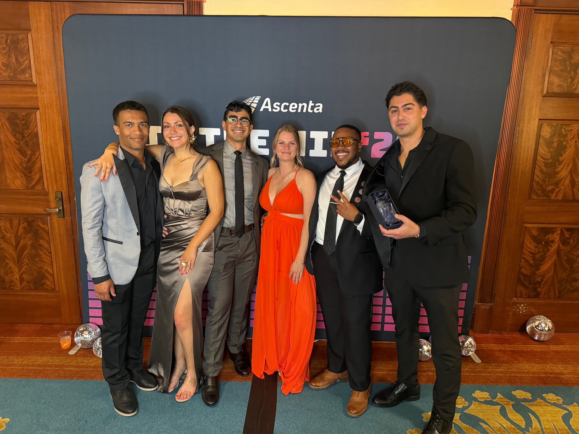 High Motive Solutions team holding trophy at Thrive25 gala
